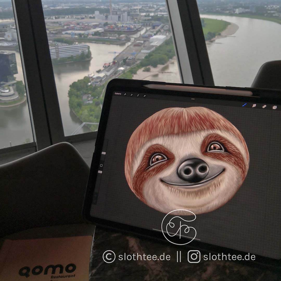 iPad showing a cute sloth from slothtee.de in the restaurant Qomo in Rhein Tower Duesseldorf, where the sloth was painted